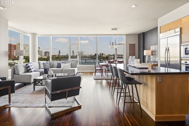 living room featuring a notable chandelier and dark wood-type flooring