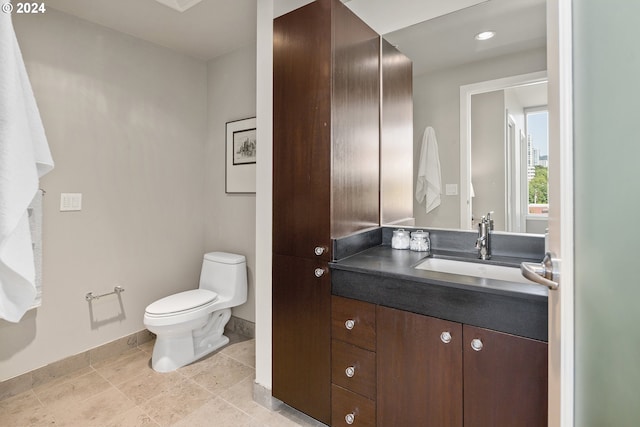 bathroom featuring tile patterned floors, vanity, and toilet