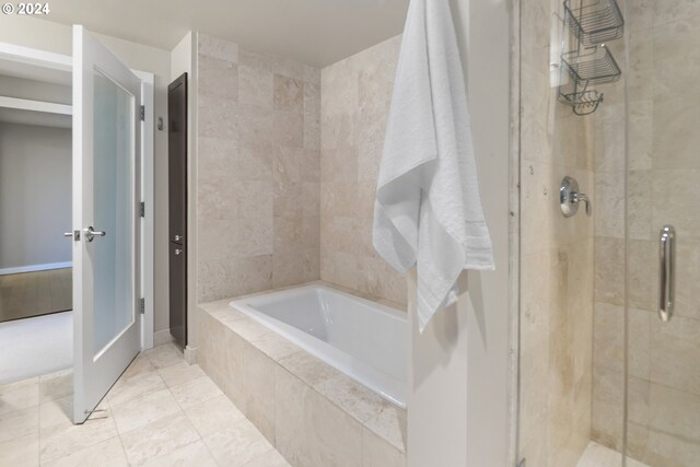 bathroom featuring tile patterned flooring and plus walk in shower