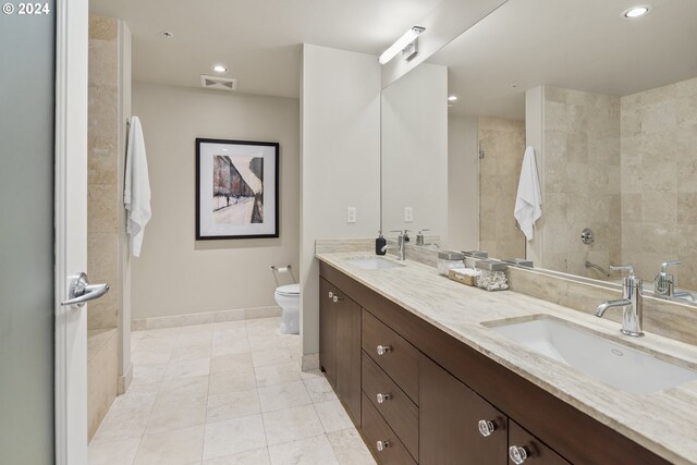 bathroom featuring vanity, toilet, and tile patterned flooring