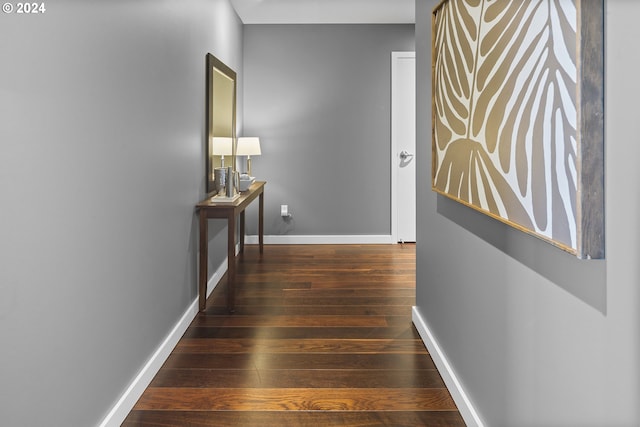 corridor with dark hardwood / wood-style floors