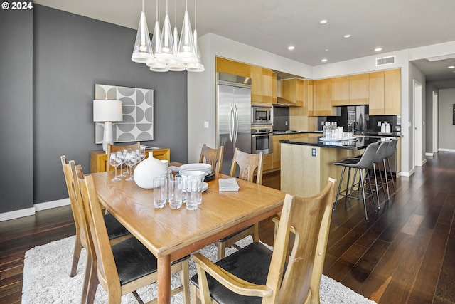 dining space with a notable chandelier and dark hardwood / wood-style floors