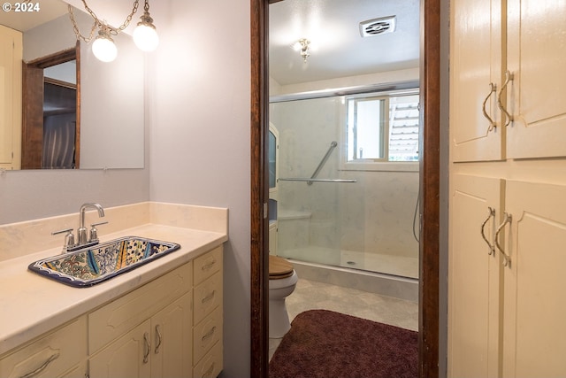 full bath with vanity, a shower stall, toilet, and visible vents