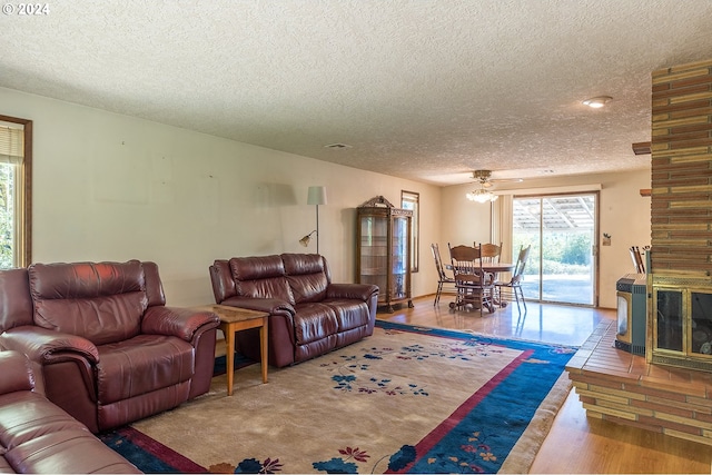 living area with wood finished floors and a textured ceiling