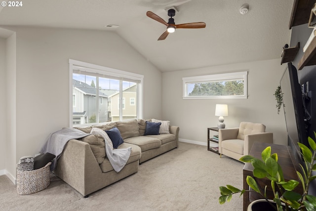 living room featuring ceiling fan, carpet floors, and vaulted ceiling