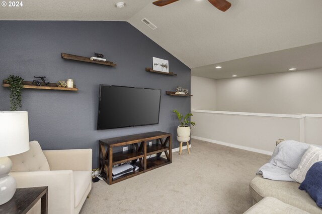 carpeted living room with ceiling fan and lofted ceiling