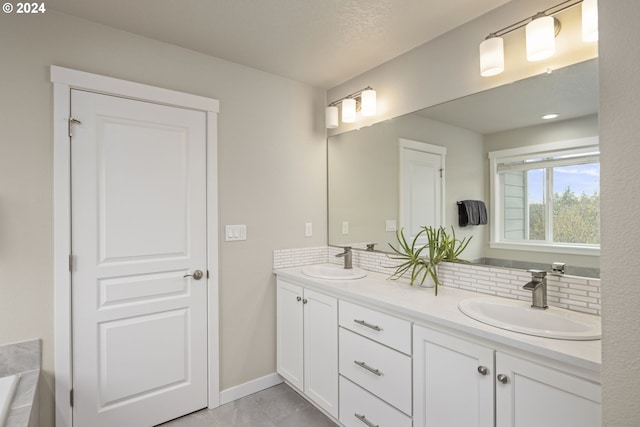 bathroom with vanity, a textured ceiling, and backsplash