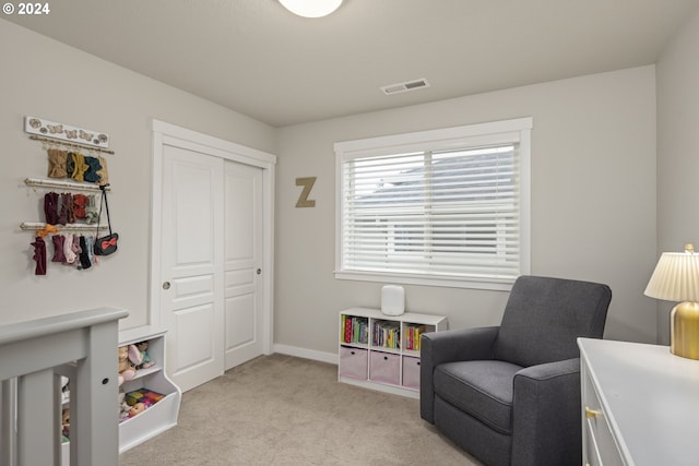 sitting room featuring light carpet