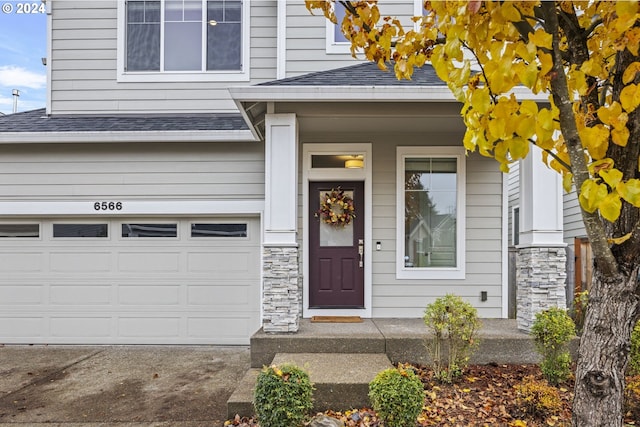 doorway to property with a garage