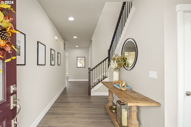 corridor with dark hardwood / wood-style flooring