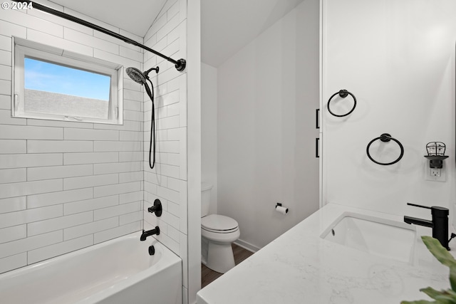 full bathroom featuring toilet, hardwood / wood-style floors, tiled shower / bath, and vanity