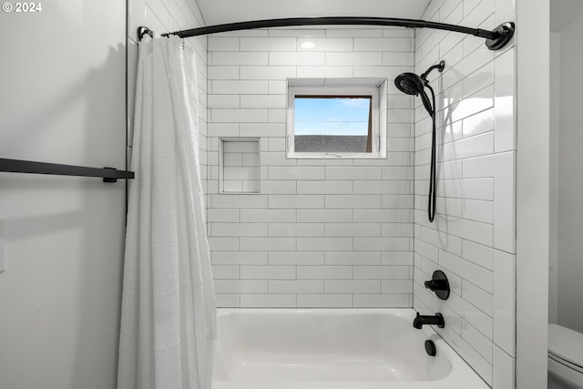 bathroom with toilet and shower / bath combo