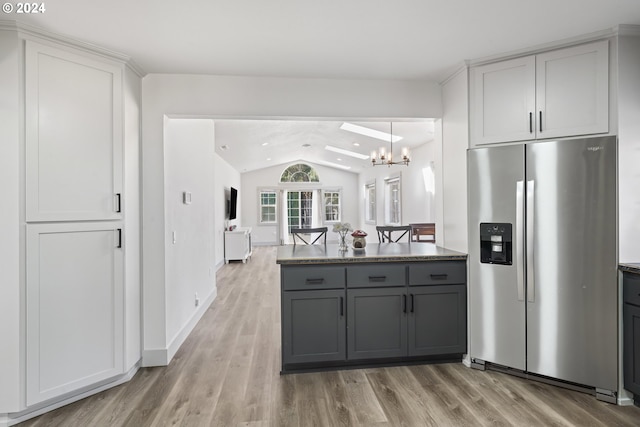 kitchen with gray cabinetry, light hardwood / wood-style flooring, a chandelier, stainless steel refrigerator with ice dispenser, and vaulted ceiling