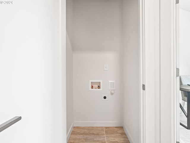 laundry area with laundry area, hookup for a washing machine, electric dryer hookup, and baseboards