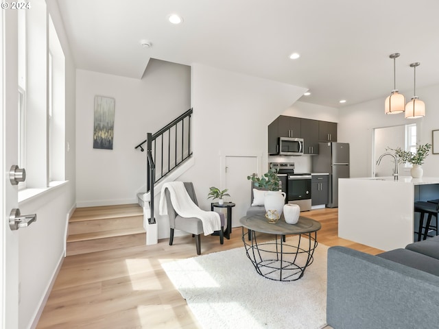 living room with sink and light hardwood / wood-style floors