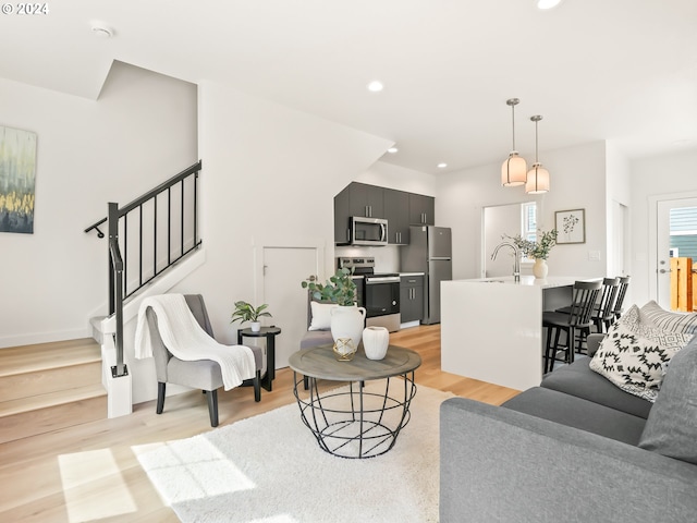 living room featuring light wood-type flooring and sink