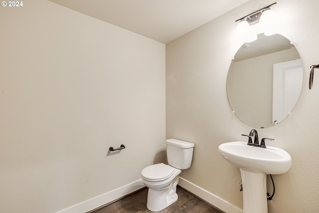 bathroom featuring hardwood / wood-style floors, sink, and toilet