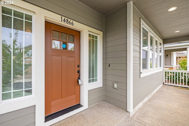 view of exterior entry featuring covered porch