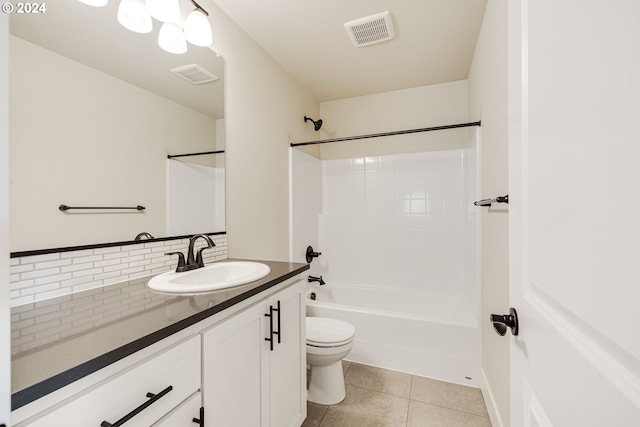 full bathroom featuring vanity, backsplash, washtub / shower combination, tile patterned floors, and toilet