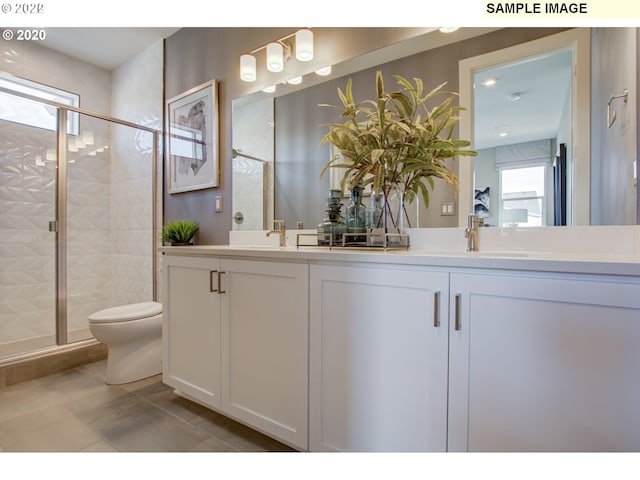 bathroom featuring vanity, an enclosed shower, toilet, and tile patterned floors