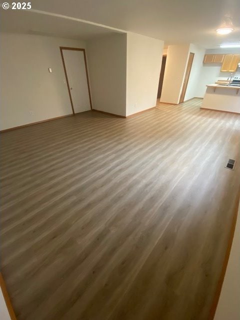 unfurnished living room with hardwood / wood-style floors