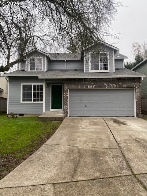 front of property featuring a front yard and a garage