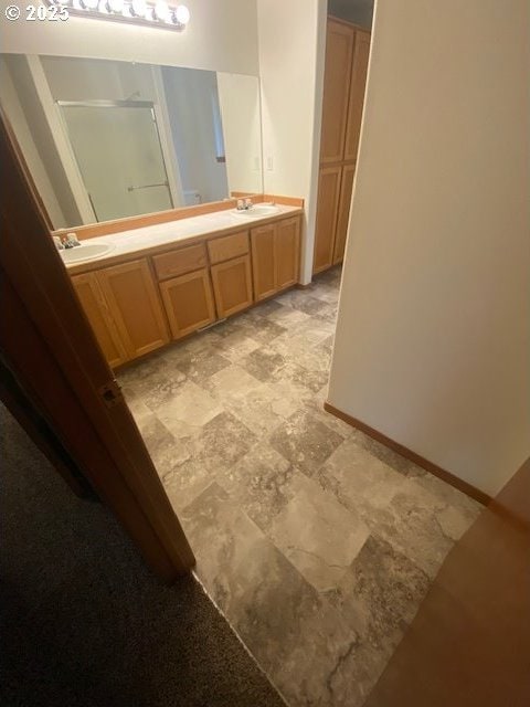 bathroom with vanity and a shower with shower door