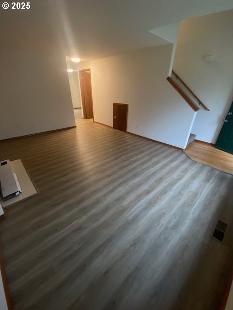 unfurnished living room featuring wood-type flooring