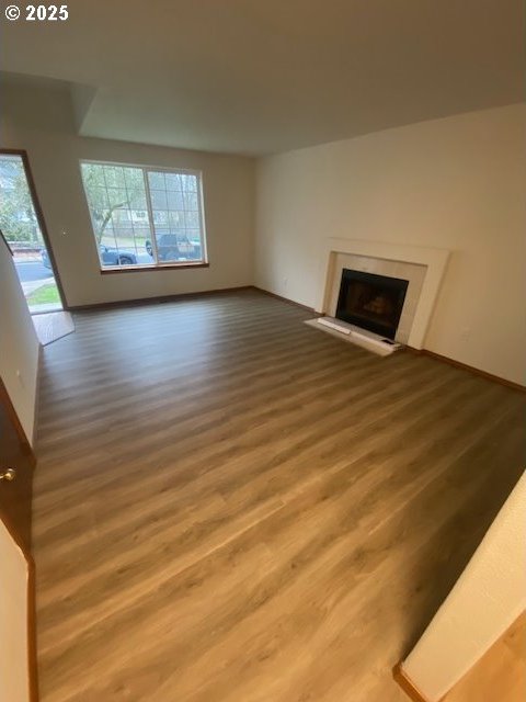 unfurnished living room featuring wood-type flooring