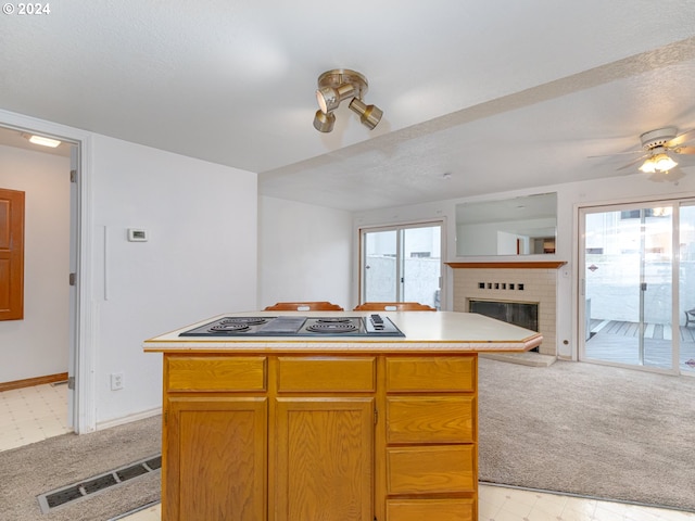 3242 NE 29th St, Gresham, OR 97030 - kitchen with light carpet, cooktop, open floor plan, and healthy amount of natural light