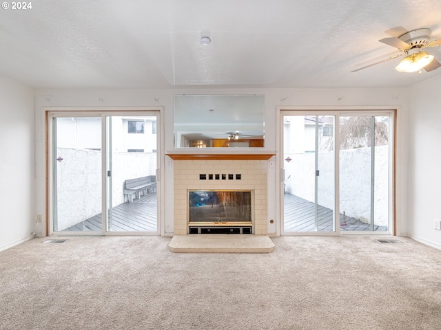 3242 NE 29th St, Gresham, OR 97030 - unfurnished living room featuring carpet floors, a ceiling fan, a brick fireplace, and a textured ceiling