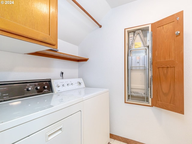 washroom featuring baseboards, cabinet space, and washing machine and clothes dryer