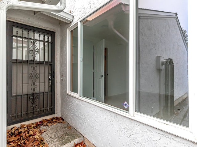 property entrance with stucco siding