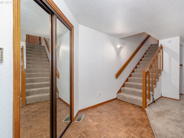 3242 NE 29th St, Gresham, OR 97030 - staircase featuring a textured ceiling and baseboards