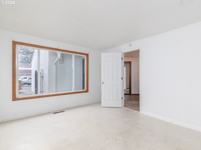 empty room with light floors, baseboards, and visible vents