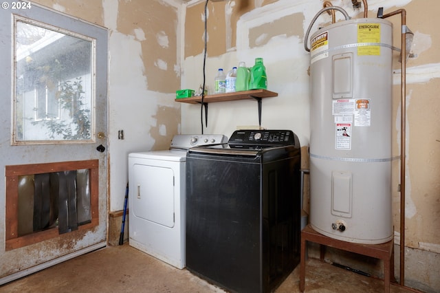 washroom with electric water heater and independent washer and dryer