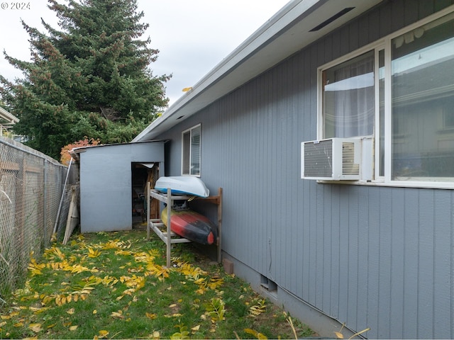 view of property exterior featuring cooling unit and a storage shed