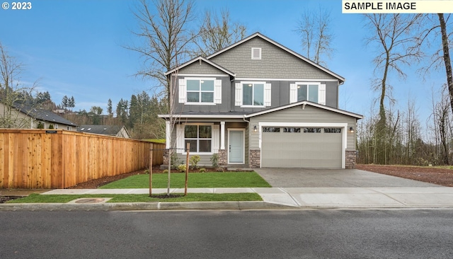 craftsman-style home featuring a front yard and a garage