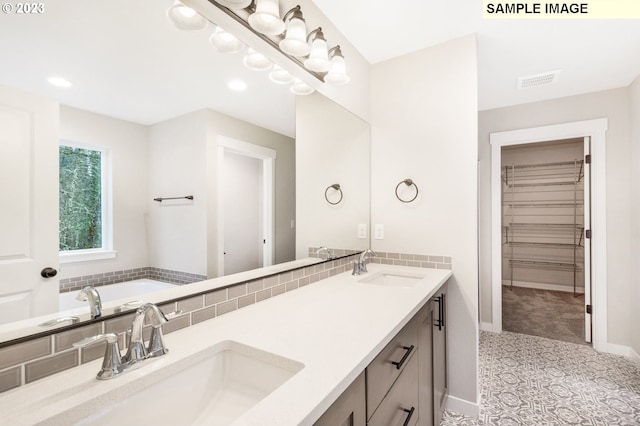 bathroom with vanity and a washtub