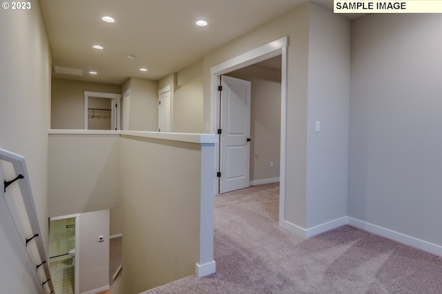 hall featuring light colored carpet