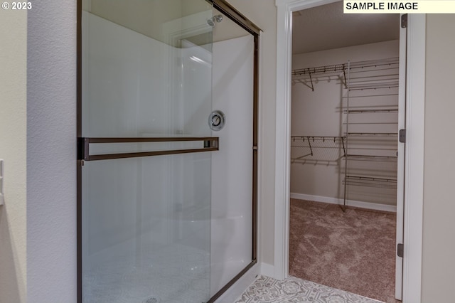 bathroom with a shower with shower door