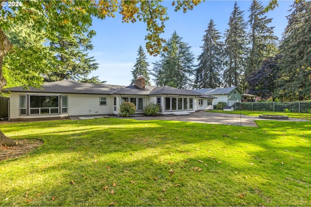 view of front of property with a patio and a front lawn