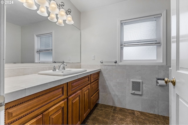 bathroom featuring vanity, heating unit, tile walls, and tile patterned floors