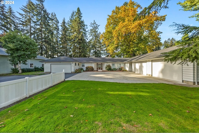 view of front of property with a front yard and a garage