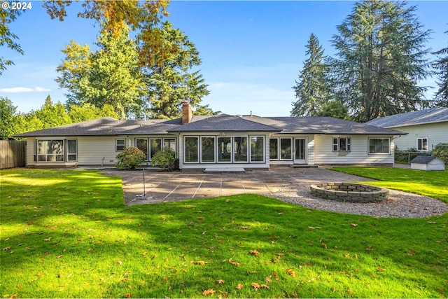 rear view of property featuring a patio area and a lawn