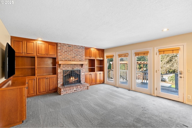 unfurnished living room featuring light carpet, a textured ceiling, and a fireplace