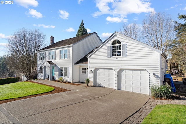 view of front facade with a garage and a front lawn