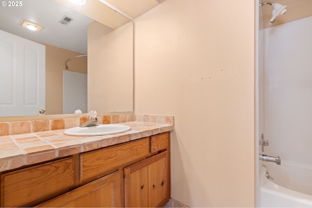 bathroom with bathtub / shower combination and vanity