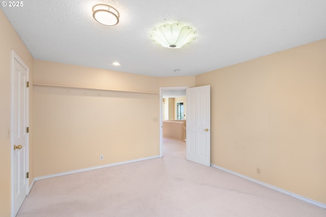 carpeted spare room featuring a textured ceiling