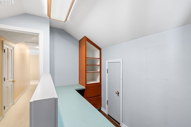 hallway featuring vaulted ceiling